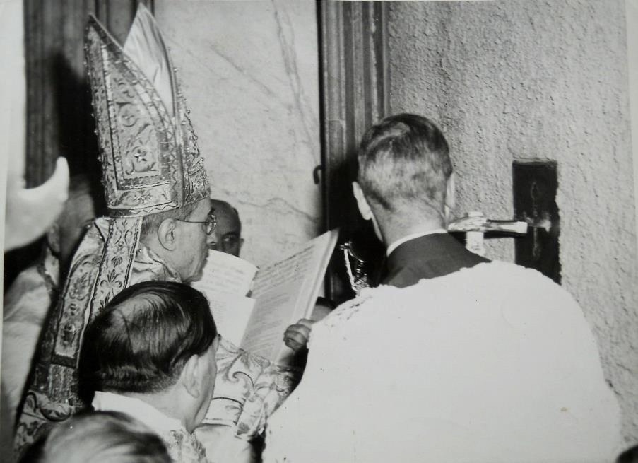 Die heilige Pforte wird vom Papst zu Beginn des heiligen Jahres mit drei symbolischen Hammerschlägen geöffnet. Papst Pius XII und die Porta Santa.